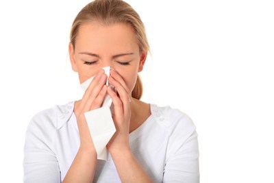 Young woman using tissue